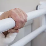 A close-up of a hand grabbing the end of the PT Rail.