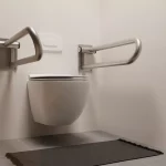 2 stainless steel fold-down rails offer support on both sides of the toilet.