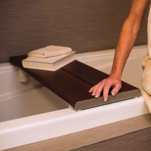 woman sitting at the bathtub with an Invisia Bath Bench