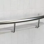 The Invisia Shampoo Shelf and grab bar installed on white tile.