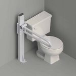 A PT rail is installed on a mast next to a toilet in a gray tile bathroom.