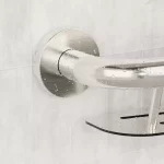 Water beading on the stainless steel of the shampoo shelf.