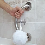 PLUS towel hook and grab bar with a luffa hanging from its hook.