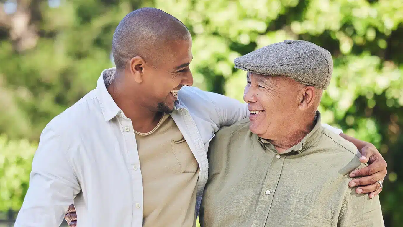 Middled-aged son having a conversation with his elderly father.